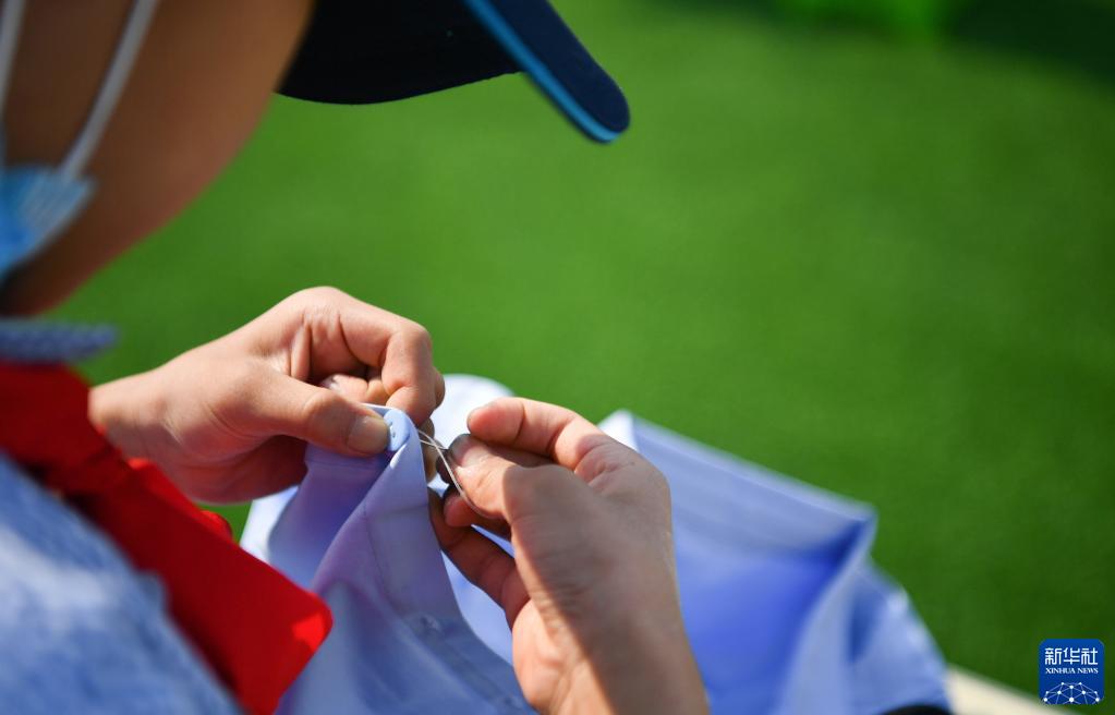 5月7日，西安市后宰门小学的学生参加缝扣子比赛。