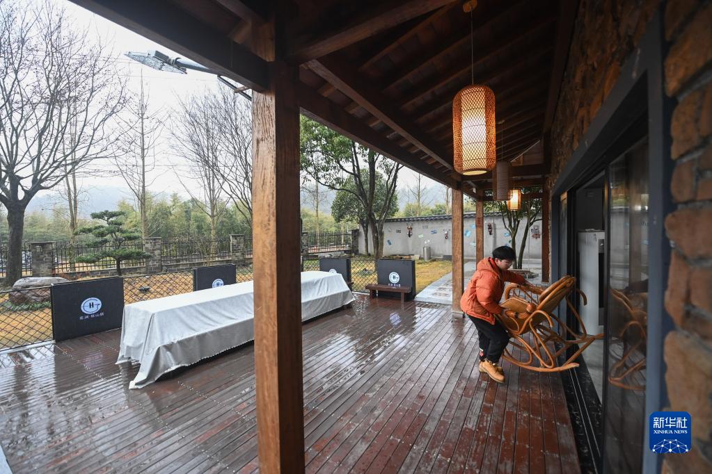 1月13日，在浙江省杭州市临安区太湖源镇横徐村，吕康在自己开办的民宿外调整桌椅摆设。