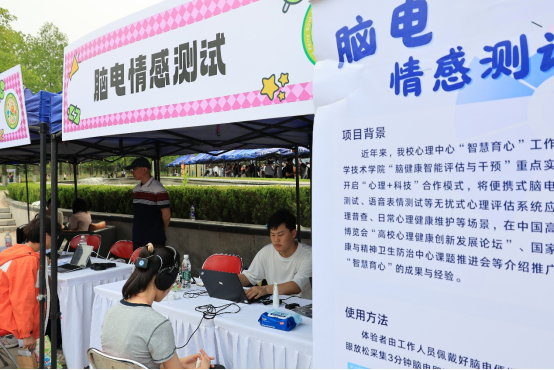 活动现场，参与者体验脑电情感测试。学校供图