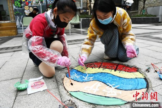 井盖“穿”新装 重庆小学生创意彩绘扮靓社区
